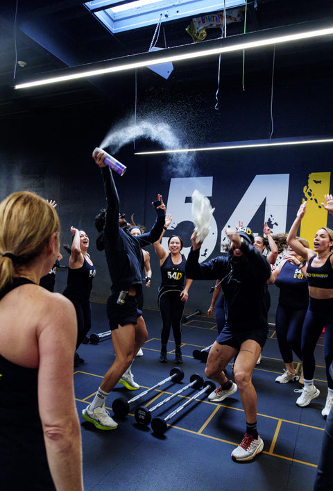 Lifestyle content of 54D Miami workout class celebrating with confetti and chalk in studio