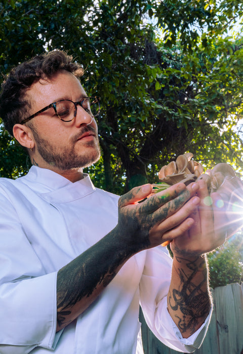 Portrait of chef from NoManners restaurant holding fresh mushrooms in sunlight
